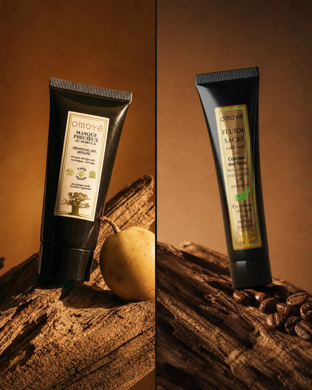 Le Masque Précieux au Marula et le Fluide Sacré au Café Vert Omoyé posés sur bois, avec un fruit de marula et des grains de café, fond terracotta